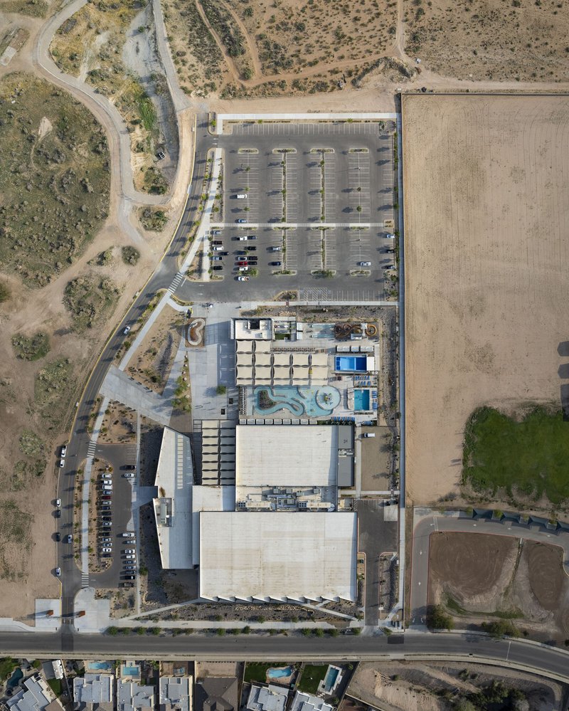 Aerial view of rooftops, parking lot, and surrounding desert terrain with access roads