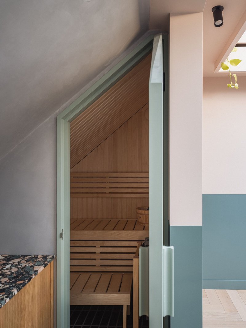 Timber sauna with slatted benches tucked under a sloped ceiling