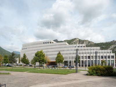 Baumschlager Eberle Wraps a Grenoble Office Building in 110 Meters of Pale Concrete Fins