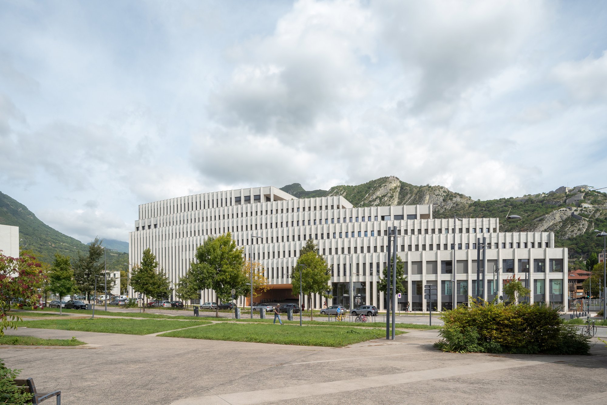 Baumschlager Eberle Wraps a Grenoble Office Building in 110 Meters of Pale Concrete Fins