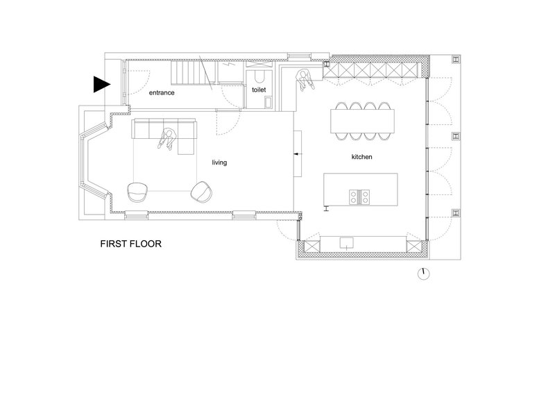 Floor plan drawing showing entrance, living area, toilet, and kitchen with central island and dining table
