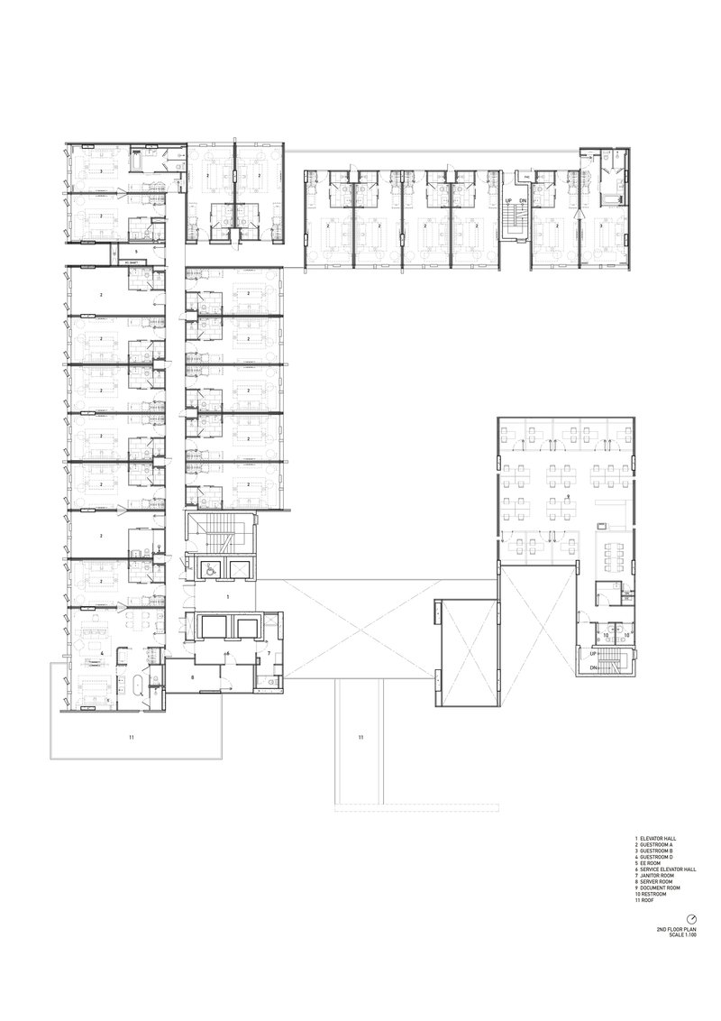 Second floor plan showing residential wings arranged around a central void