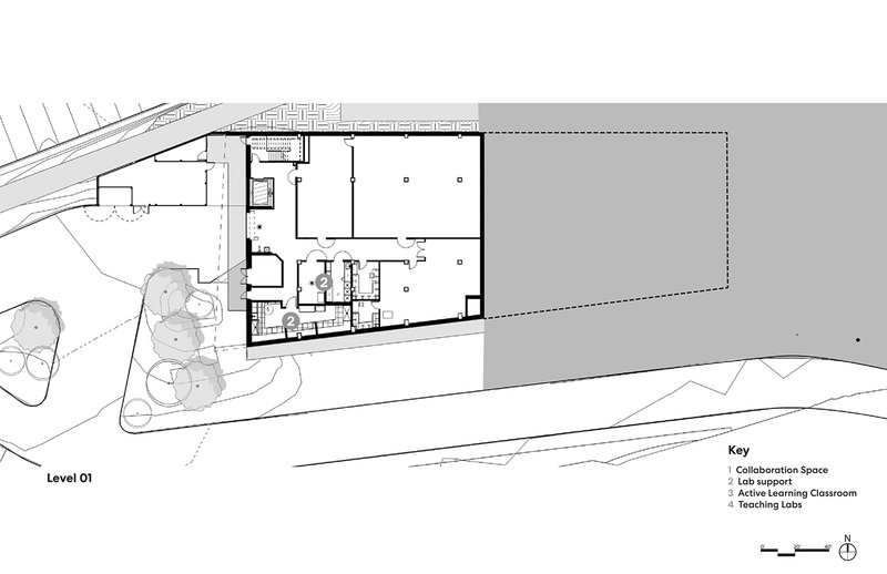 Floor plan drawing showing entry level with large open volumes and circulation core at center