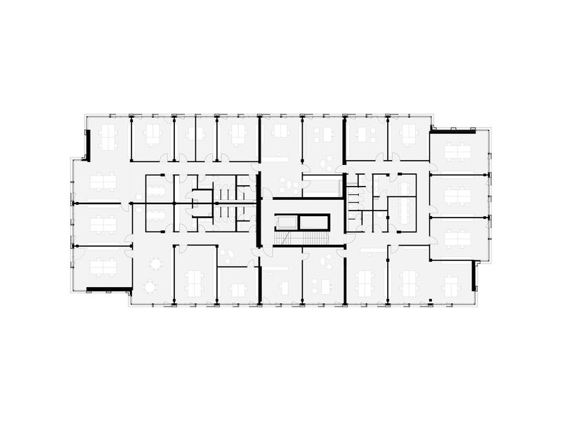Floor plan drawing showing office spaces organized around a central circulation core with two stairwells