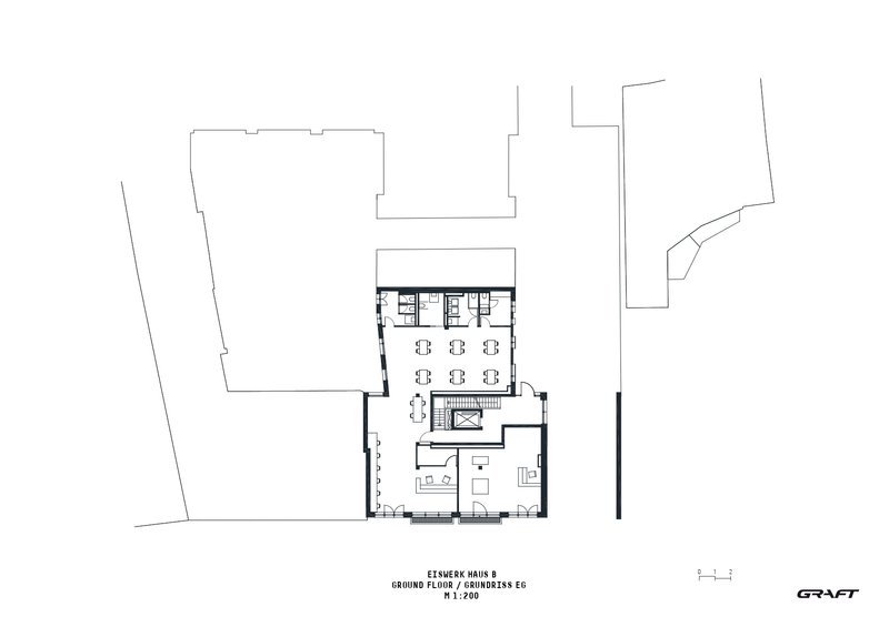 Ground floor plan drawing showing an open workspace with seating clusters and a central staircase