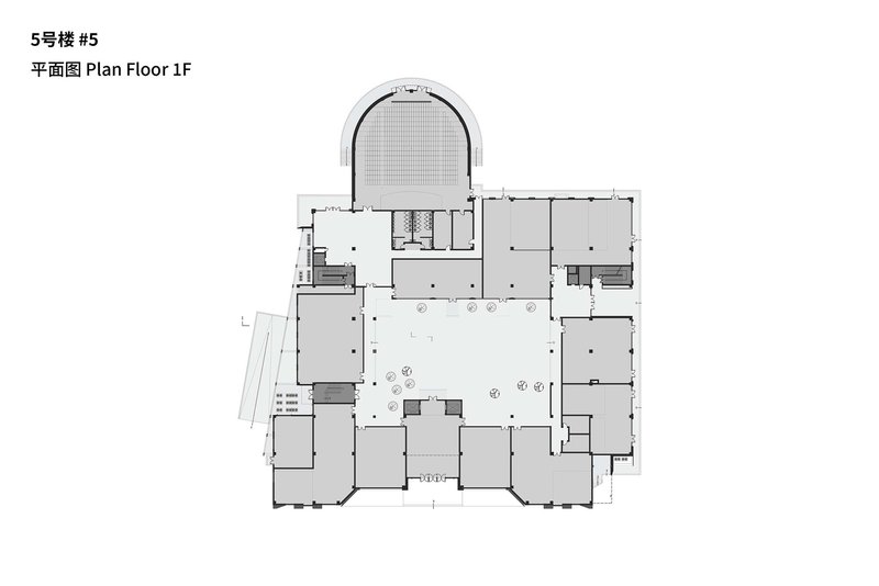 First floor plan drawing showing a central courtyard with curved auditorium volume projecting at the top