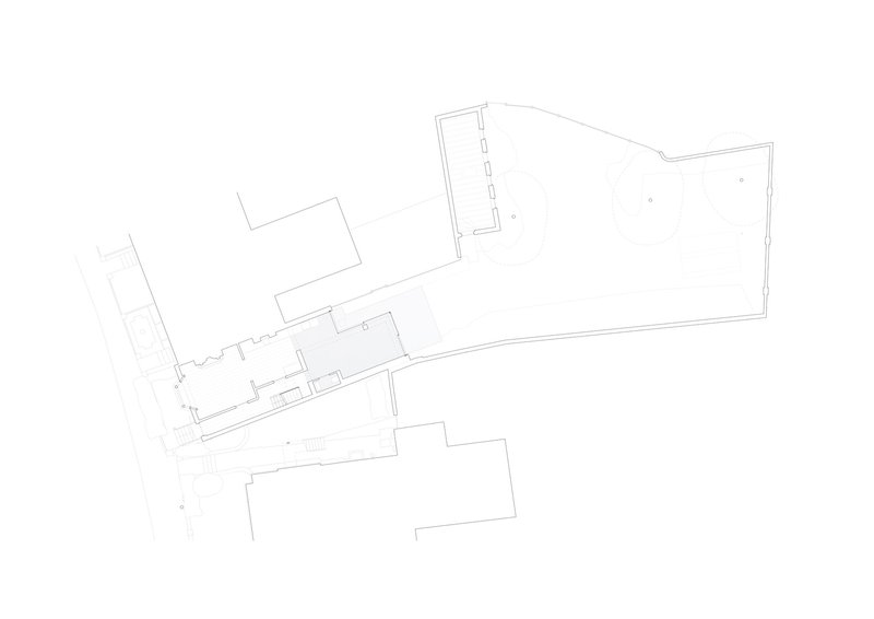 Floor plan showing an angular layout with central corridor connecting existing and new volumes