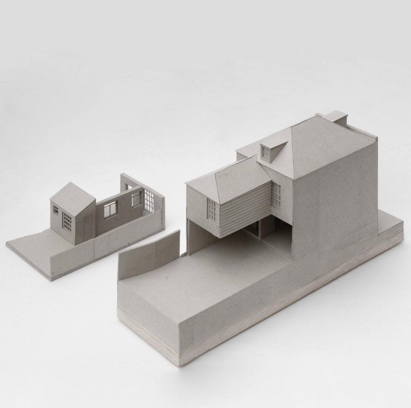 Physical model showing clustered volumes with flat roofs and fenestration on stepped platforms