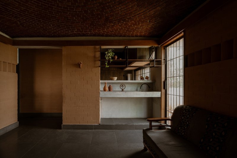 Alcove with concrete counter and timber shelves beside a frosted glass partition wall