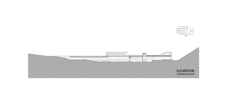 Elevation drawing depicting the low-slung building profile embedded into a sloping hillside
