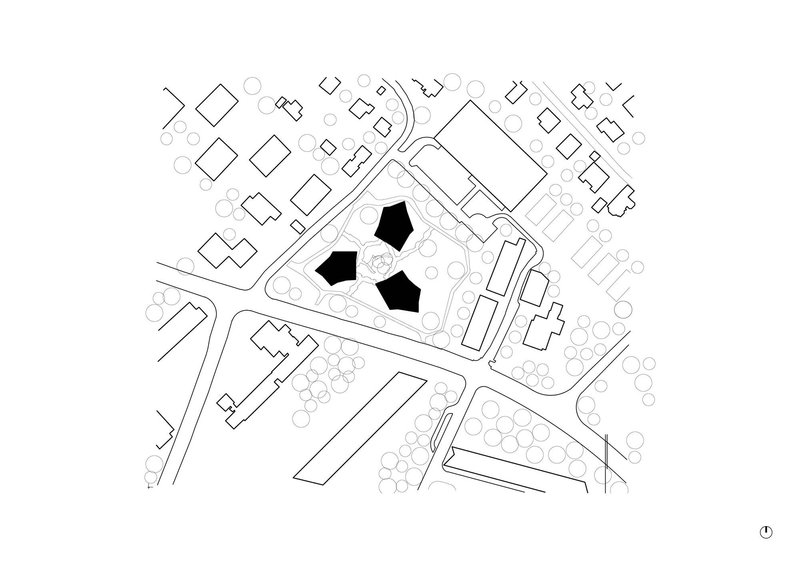 Site plan drawing showing three pentagonal building volumes in black within an urban block with surrounding streets and trees