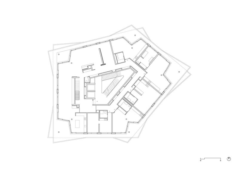 Floor plan drawing of a pentagonal level showing central stairwell and varied apartment layouts with angular walls
