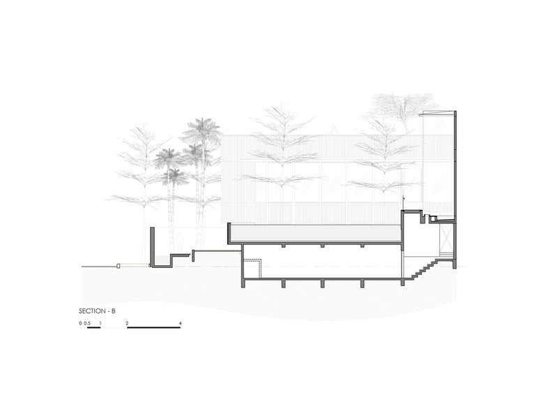 Section drawing revealing a cantilevered screen wall above a lower volume with an internal staircase