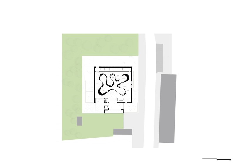 Ground floor plan drawing showing curving interior volumes within a square footprint surrounded by green space