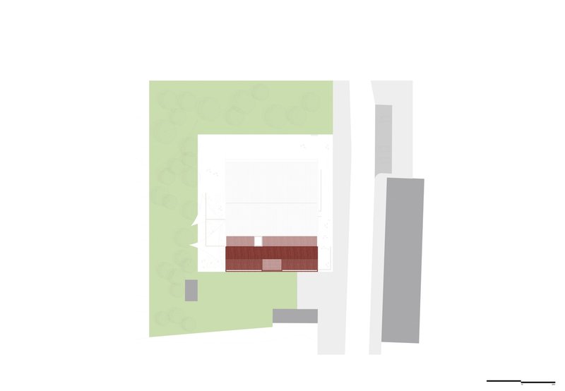 Roof plan drawing showing red terrace surfaces and rectangular volumes set within green landscaping