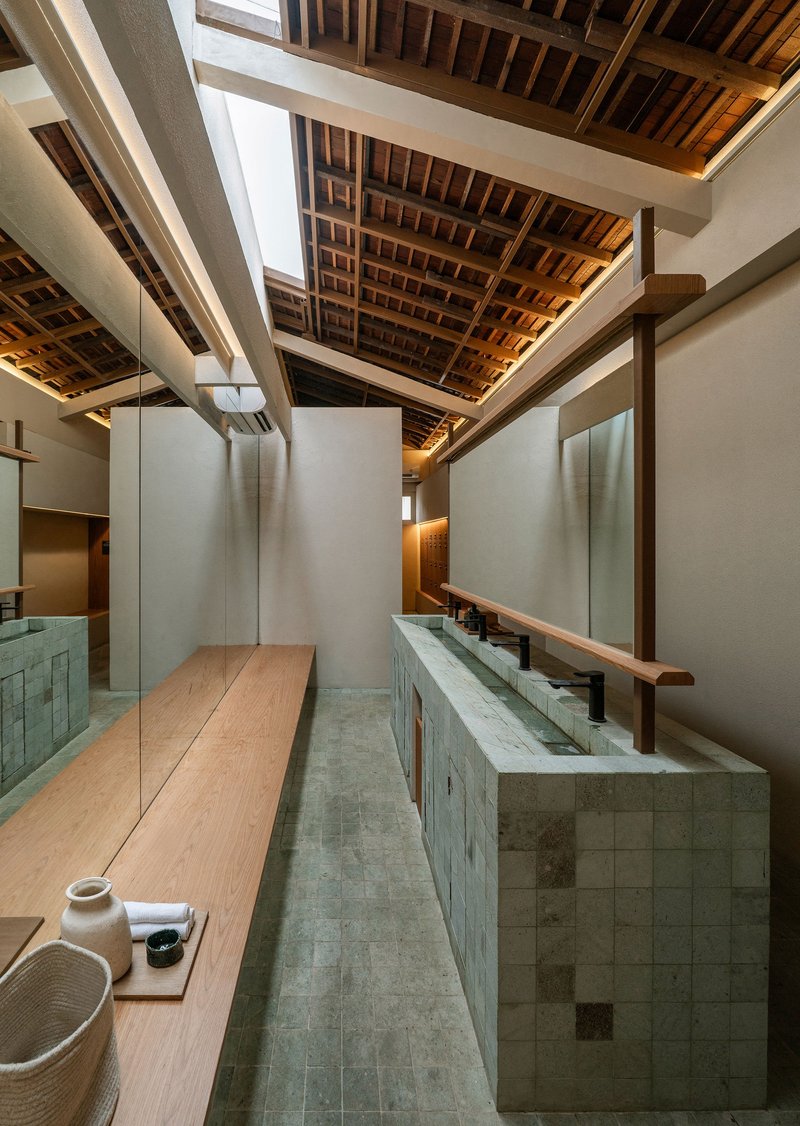 Interior view of exposed timber ceiling joists over tiled counters and skylights above