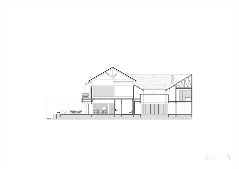 Section drawing depicting interconnected pitched roof forms with varying ceiling heights and interior furnishings