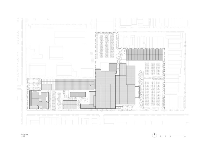 Site plan drawing showing clustered volumes with surrounding parking lots and tree-lined streets