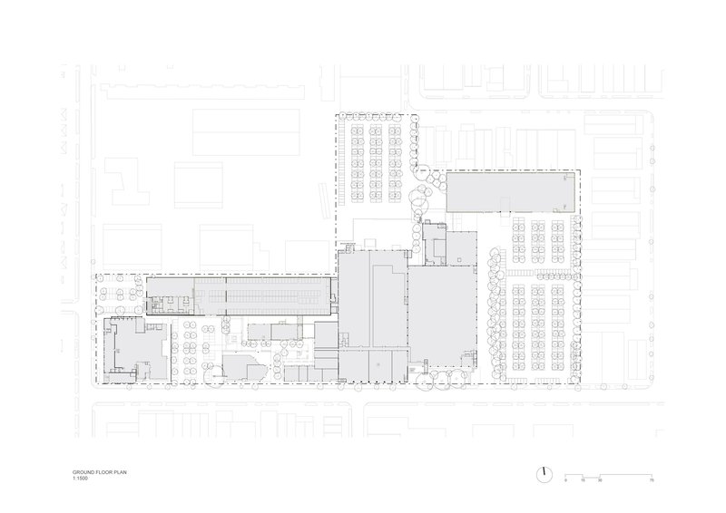 Ground floor plan drawing showing L-shaped layout with open spaces and adjacent parking areas