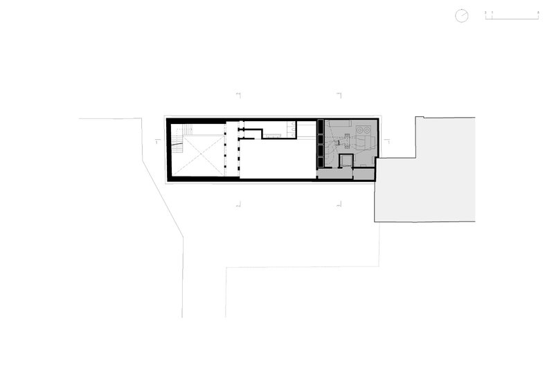 Floor plan drawing showing a long linear volume with a staircase and compact service zones