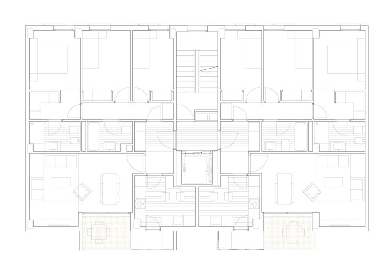 Floor plan showing symmetrical residential units arranged around a central stair and elevator core