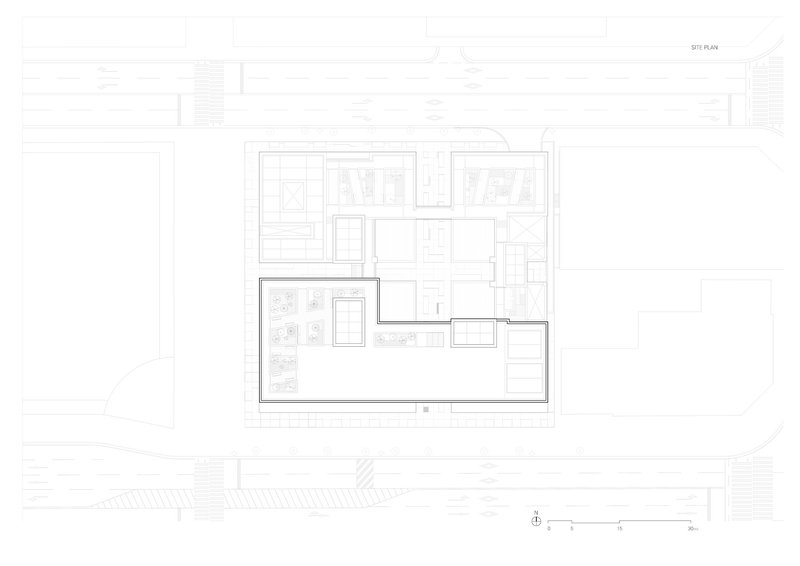 Site plan drawing showing the building footprint with a central courtyard and surrounding street context