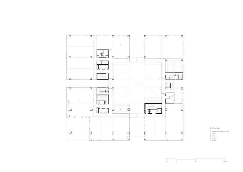 Floor plan drawing showing residential units arranged around open courtyards with structural grid