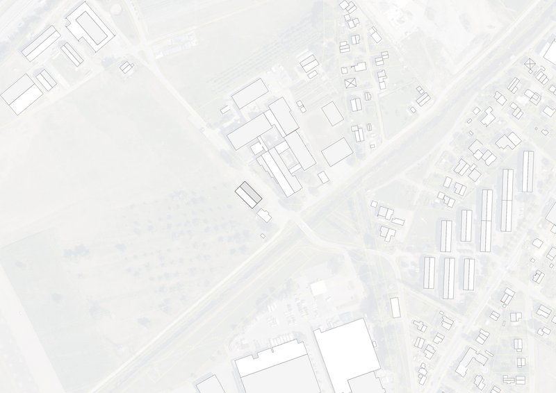 Site plan drawing showing building footprint among surrounding structures and roadways in an urban context