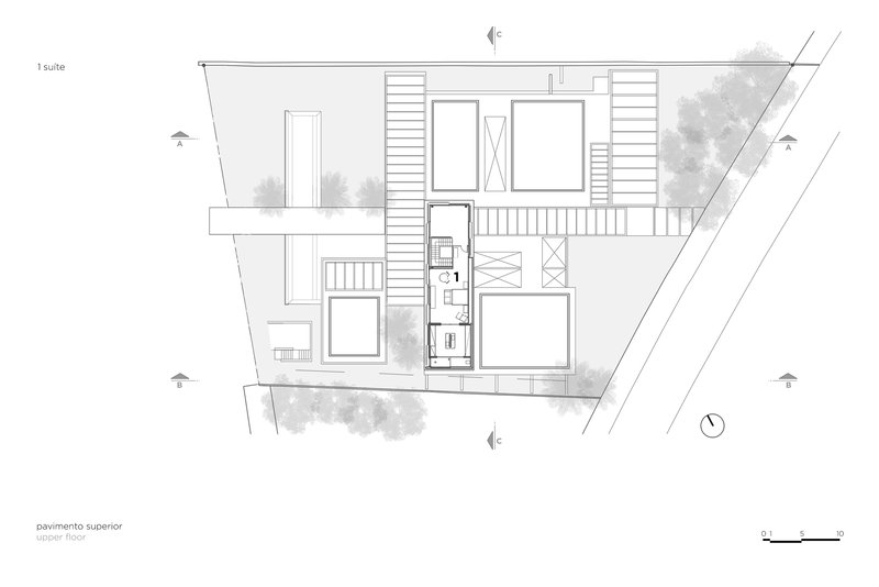 Upper floor plan drawing showing bedroom suites and terraces on the angled residential property