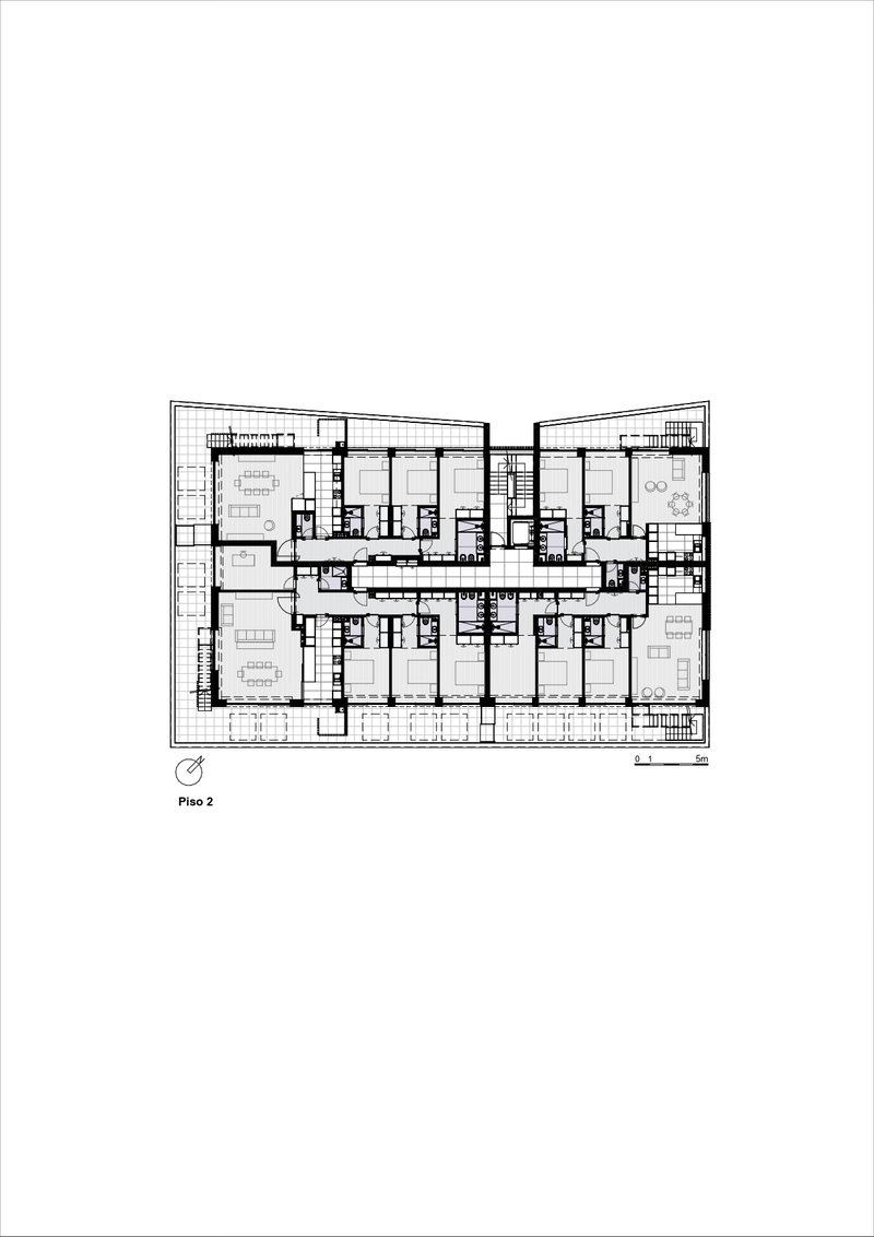 Floor plan drawing illustrating residential units flanking a central stairwell with angled facade edges