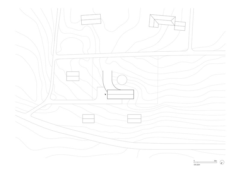 Site plan drawing with topographic contours showing building placement on sloping terrain