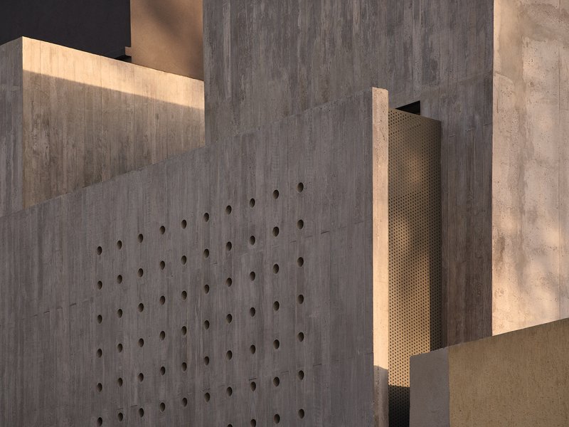 Board-formed concrete wall with dimpled tie holes illuminated by a recessed slot of warm light