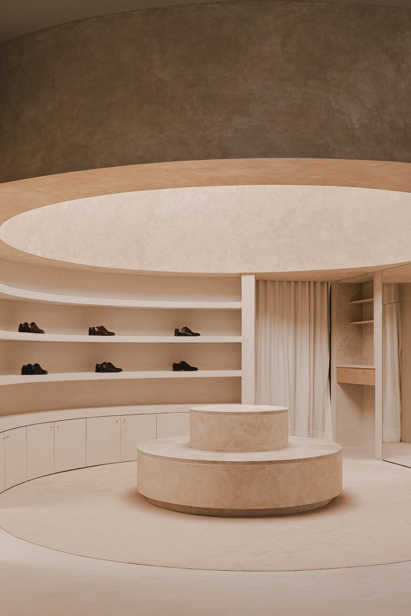 View of the tiered display podium beneath layered curved ceiling planes and a central oculus