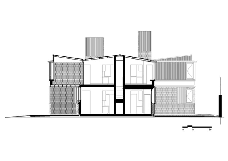 Section drawing revealing staggered volumes with textured cladding and a central staircase
