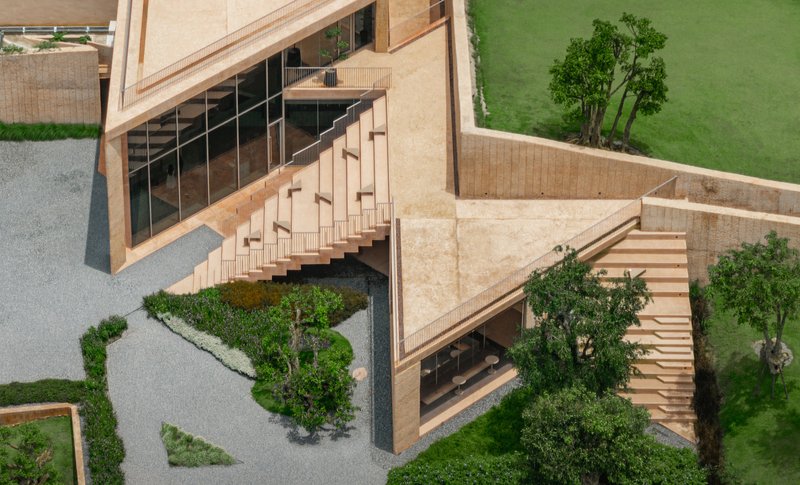 Overhead view of the courtyard with cascading stairs and planted trees between stone walls