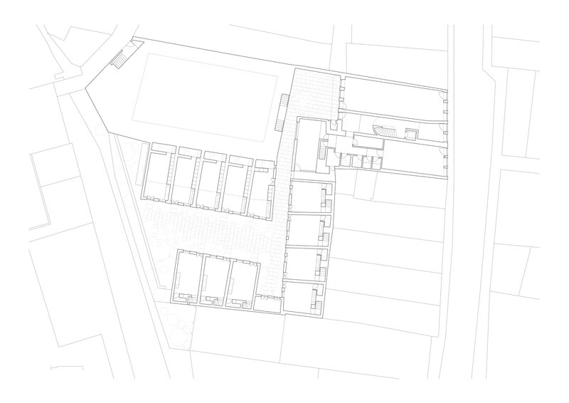 Ground floor plan drawing showing residential units arranged along two parallel bars with a courtyard