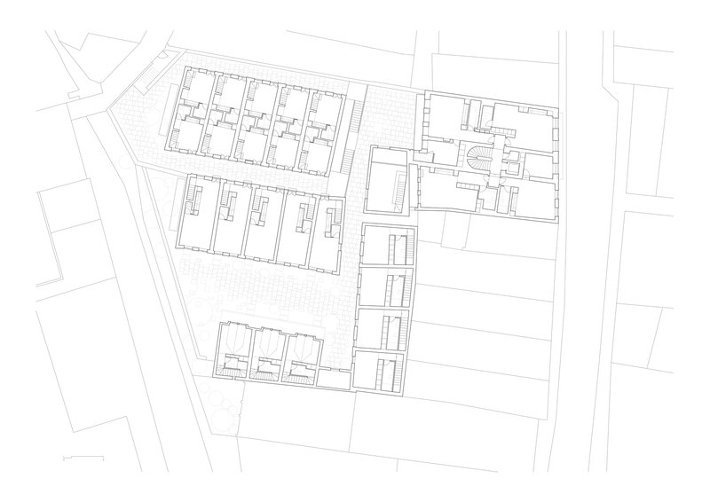 Floor plan drawing showing repeated unit layouts in two parallel blocks with central circulation spine