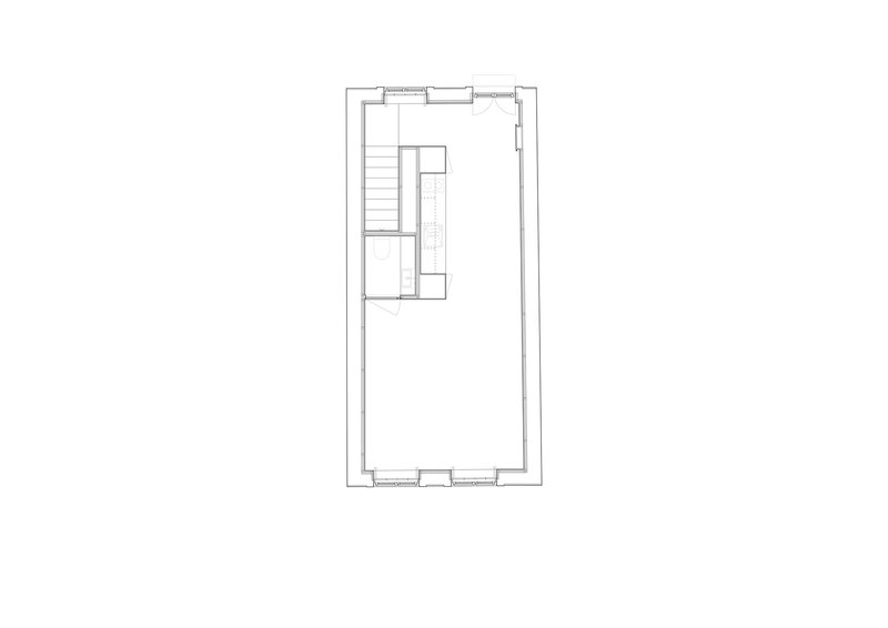 Floor plan drawing showing a rectangular volume with staircase and kitchen block at one end