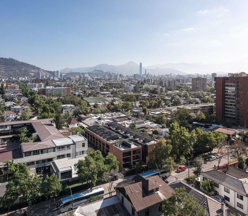 Aerial view of the low-rise brick housing blocks nestled in a residential district with mountains beyond