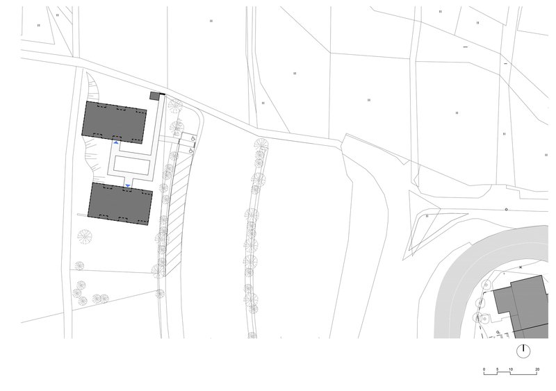 Site plan drawing showing two rectangular buildings with parking and landscaping along a curved road
