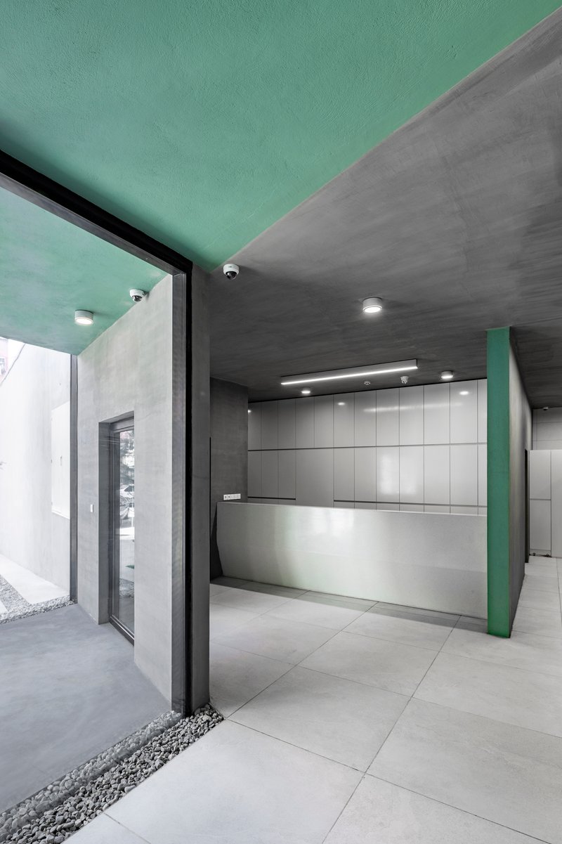 Kitchen with mint green ceiling, grey tile walls, and large floor-to-ceiling glass doors opening to courtyard