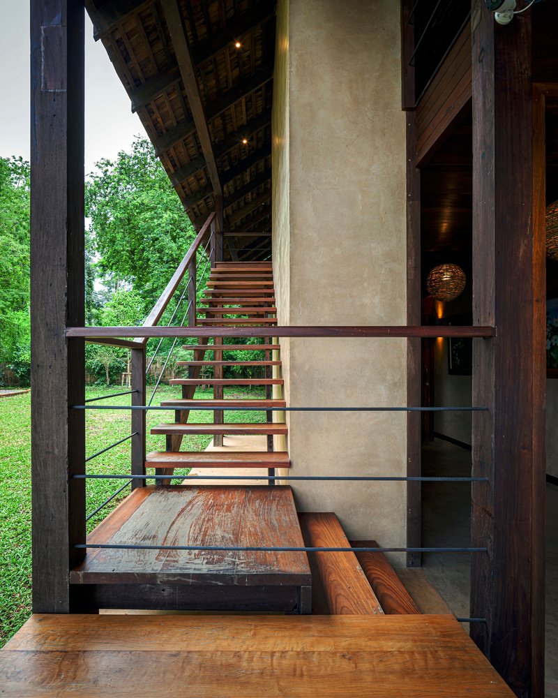 Interior view from timber stair landing showing polished plaster core wall and open tread staircase with steel railings