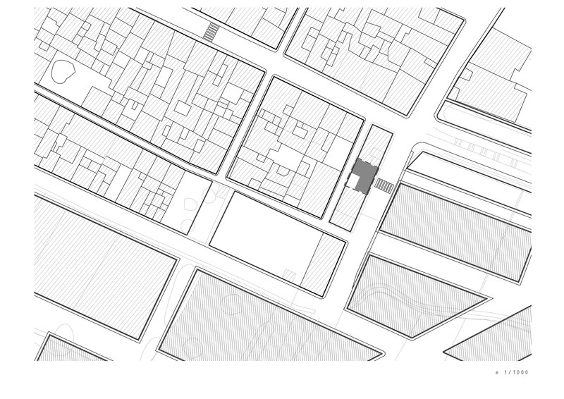 Site plan drawing showing the building footprint highlighted among surrounding urban blocks and streets