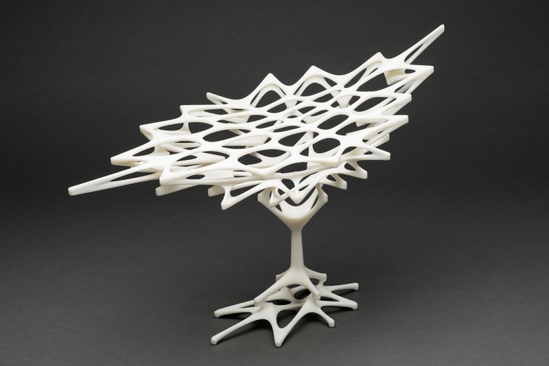 White physical model showing a branching organic roof structure rising from a single tree-like base