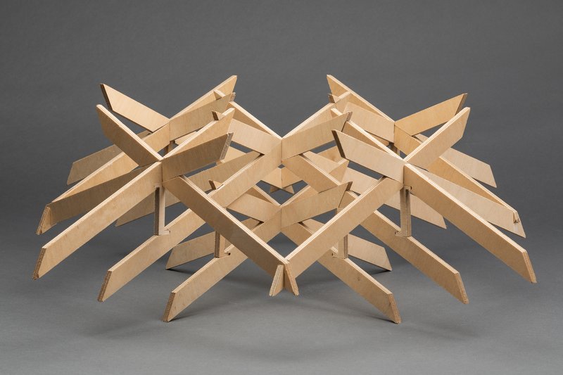Plywood structural model with interlocking beams arranged in a radiating grid pattern