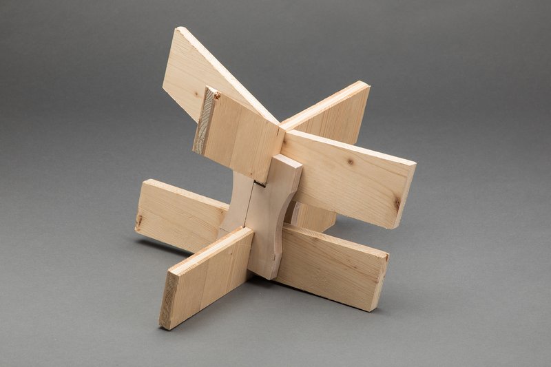 Timber joinery prototype showing four interlocking plywood panels meeting at a central notched connection