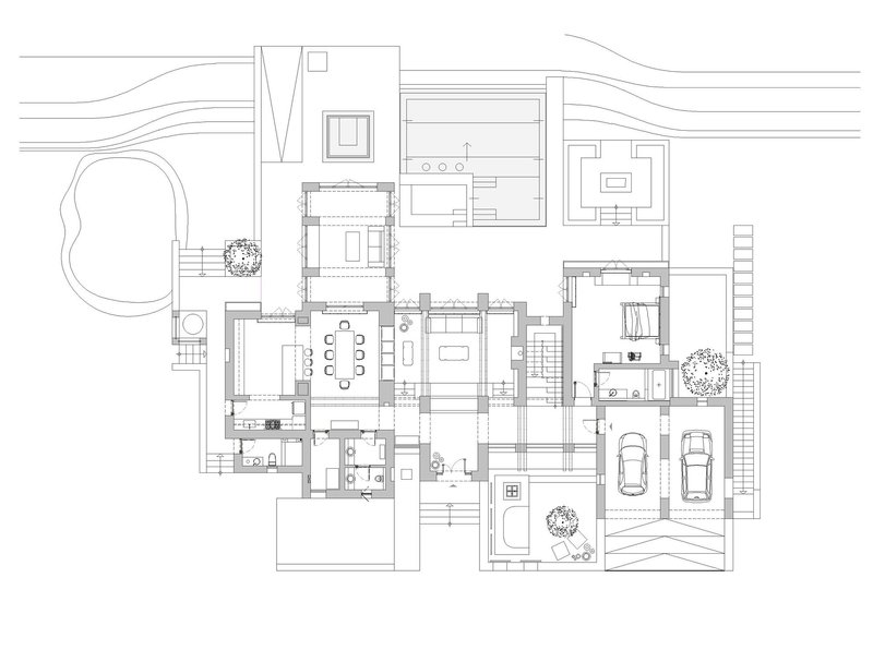 Floor plan drawing depicting room divisions, furniture placement, and site context with contour lines