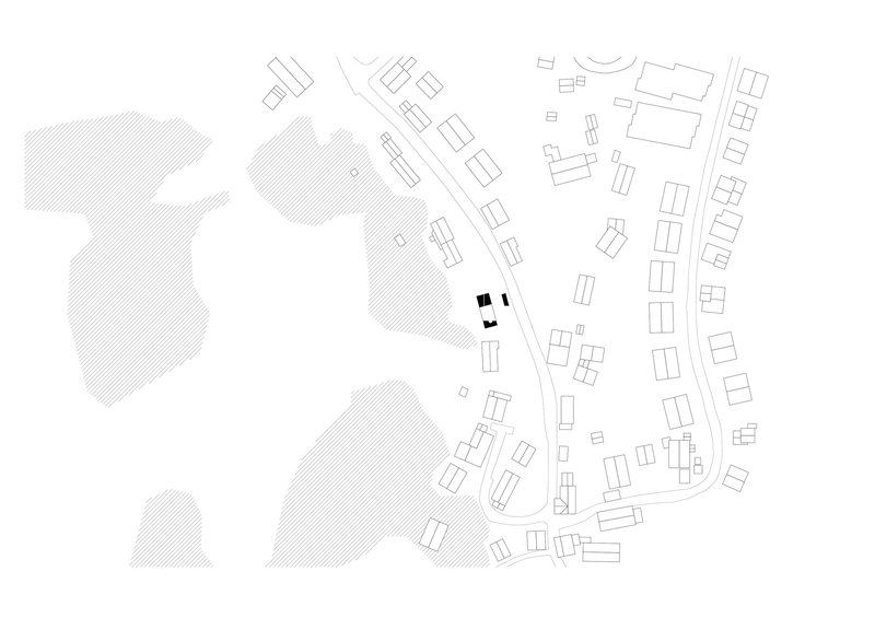 Site plan drawing showing a compact building cluster among diagonal streets and scattered neighboring structures