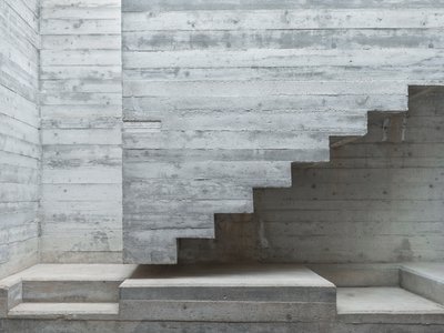 MODEL Carves a Scarpa-Inspired Concrete Core Through a Maltese Period House for Two Sisters