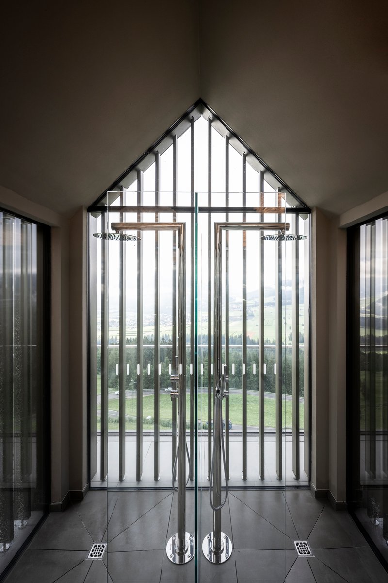 Interior entrance vestibule with vertical slat door and polished chrome handles on tiled floor